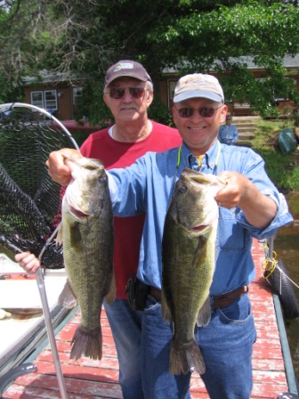Dave Caithamer with a pair of nice largemouth bass from Benoit Lake, June 6, 2010.  The fish were 20 and 21.25 inches.  Cousin George was net-man.  Both fish were released.
