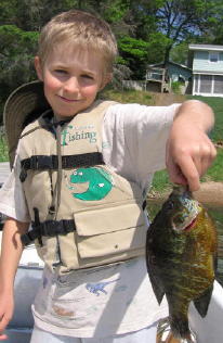 Ben with a 9 inch pumpkinseed he caught and released on Benoit Lake in May 19, 2007.  It was the resort record for more than 2 years.