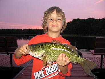 Brenan S. couldn't be prouder of this nice bass he caught and released from our dock, July.