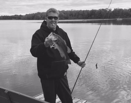 Mark C. with another bass from the dock of Rainbow Bay Resort, May 2020. C&R.