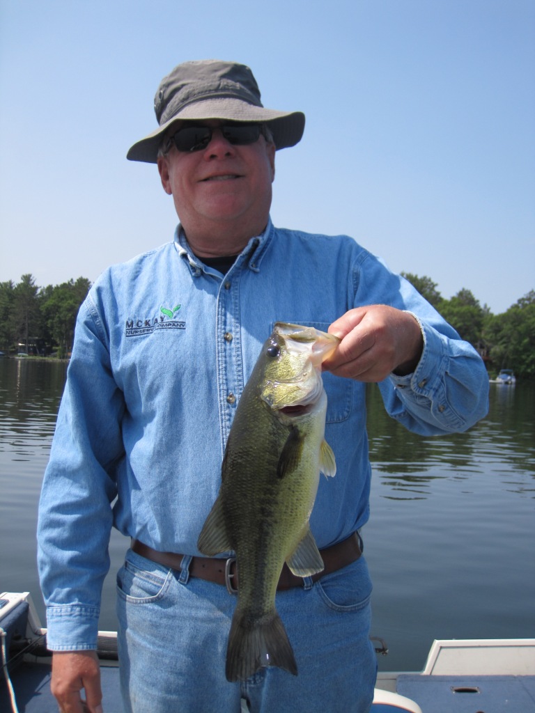 Bryan A. with a bass from a Burnett County Lake, June 2023.