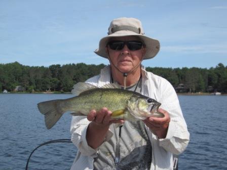 Dennis R. with a 17-inch bass that he caught and released, Burnett County Lake, June 2018.