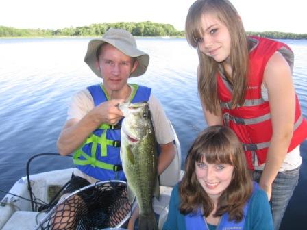 Jake C. caught and released this nice 20 inch bass on Benoit Lake on June 25.  Friends, Megan (seated) and Lora helped land the beauty.