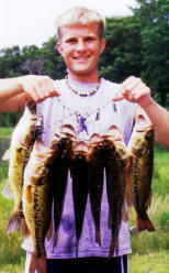 Joey R. with a nice stringer of eating bass caught on a nearby lake, 2004.