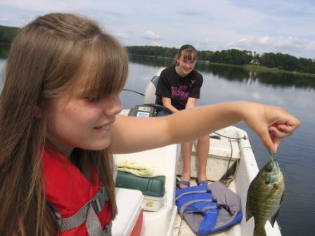 Lora G. with a bluegill Megan K. caught on Benoit Lake.  Apparently Megan was afraid to touch the fish.