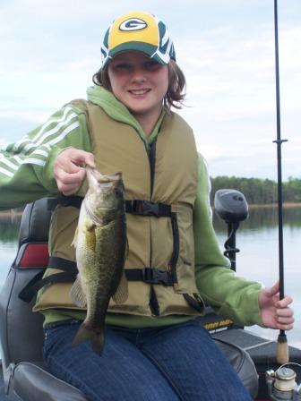 Megan M. with a nice bass she caught on a nearby lake.  Photo by Scott, her father.