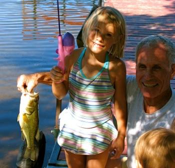 Molly M. caught and released this bass on our main dock in August, 2008.  Grandpa Bob was there to help handle the situation.  Photo courtesy of Dave Metcalf.
