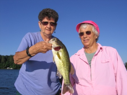 Rennie H. and Judy B. are all smiles after landing this nice bass one morning on Benoit Lake, July 2013.